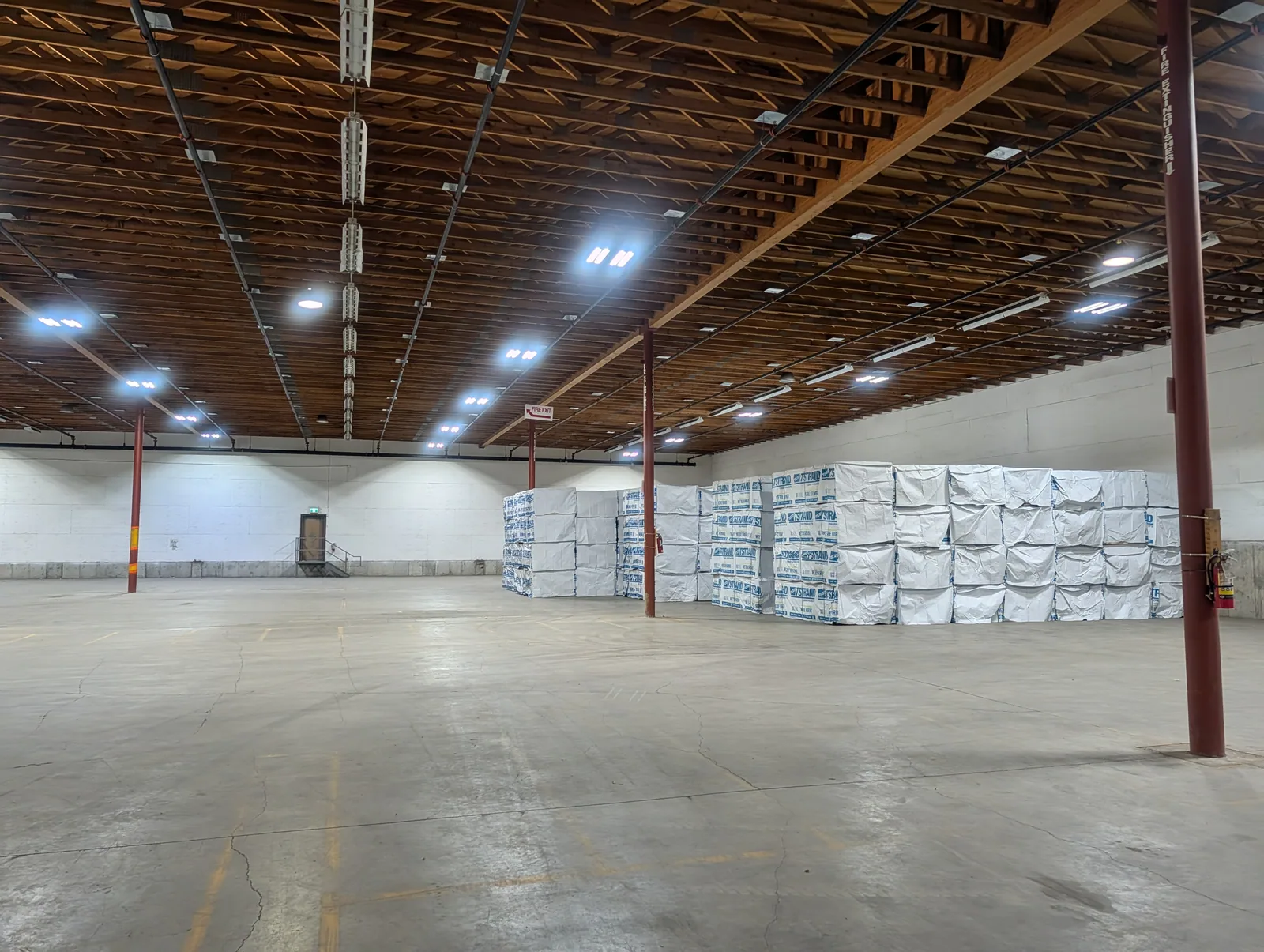 Floor-stacked palletized inventory inside a Hawkeye dry warehouse in Kelowna
